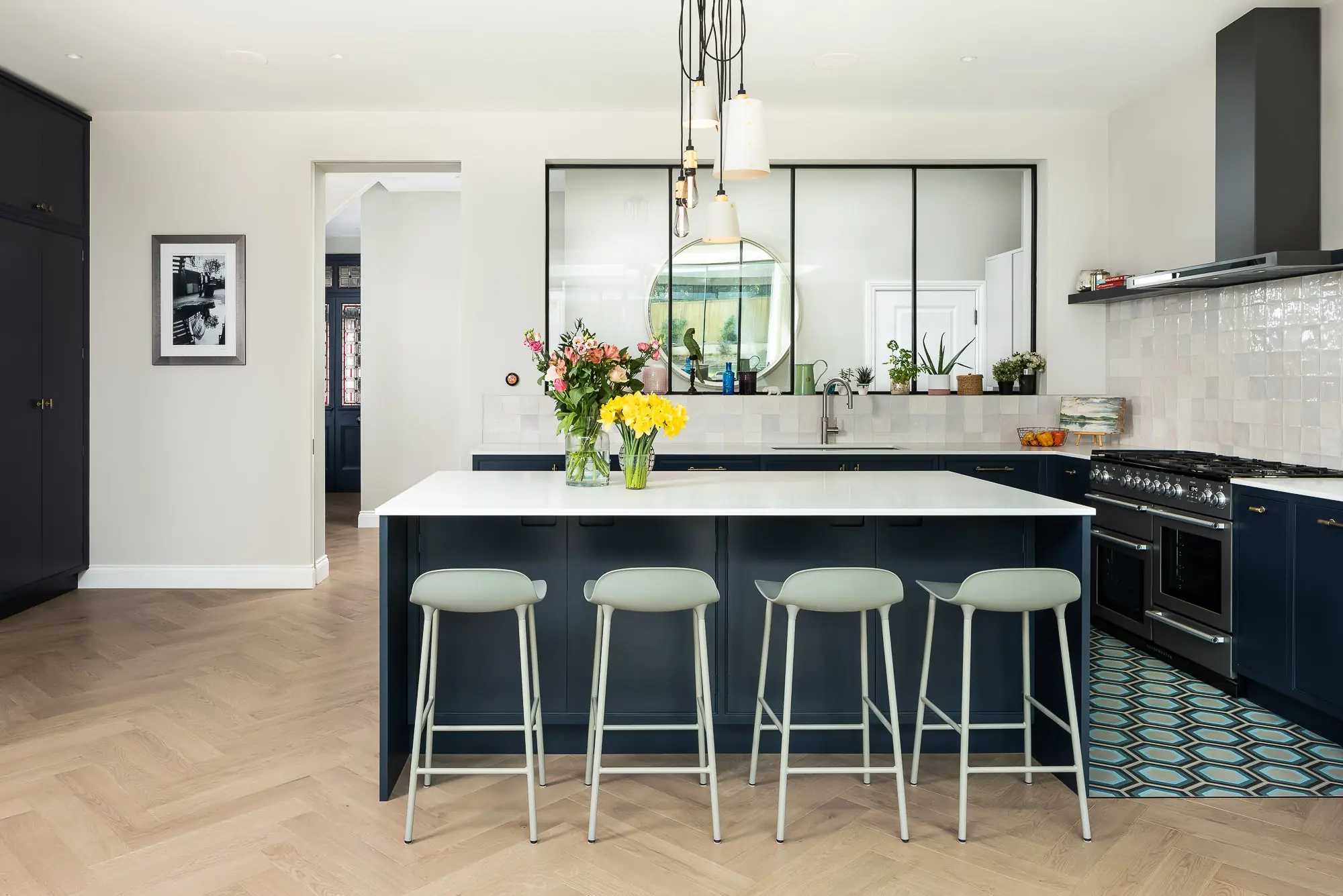 Navy kitchen island with range and steel screen