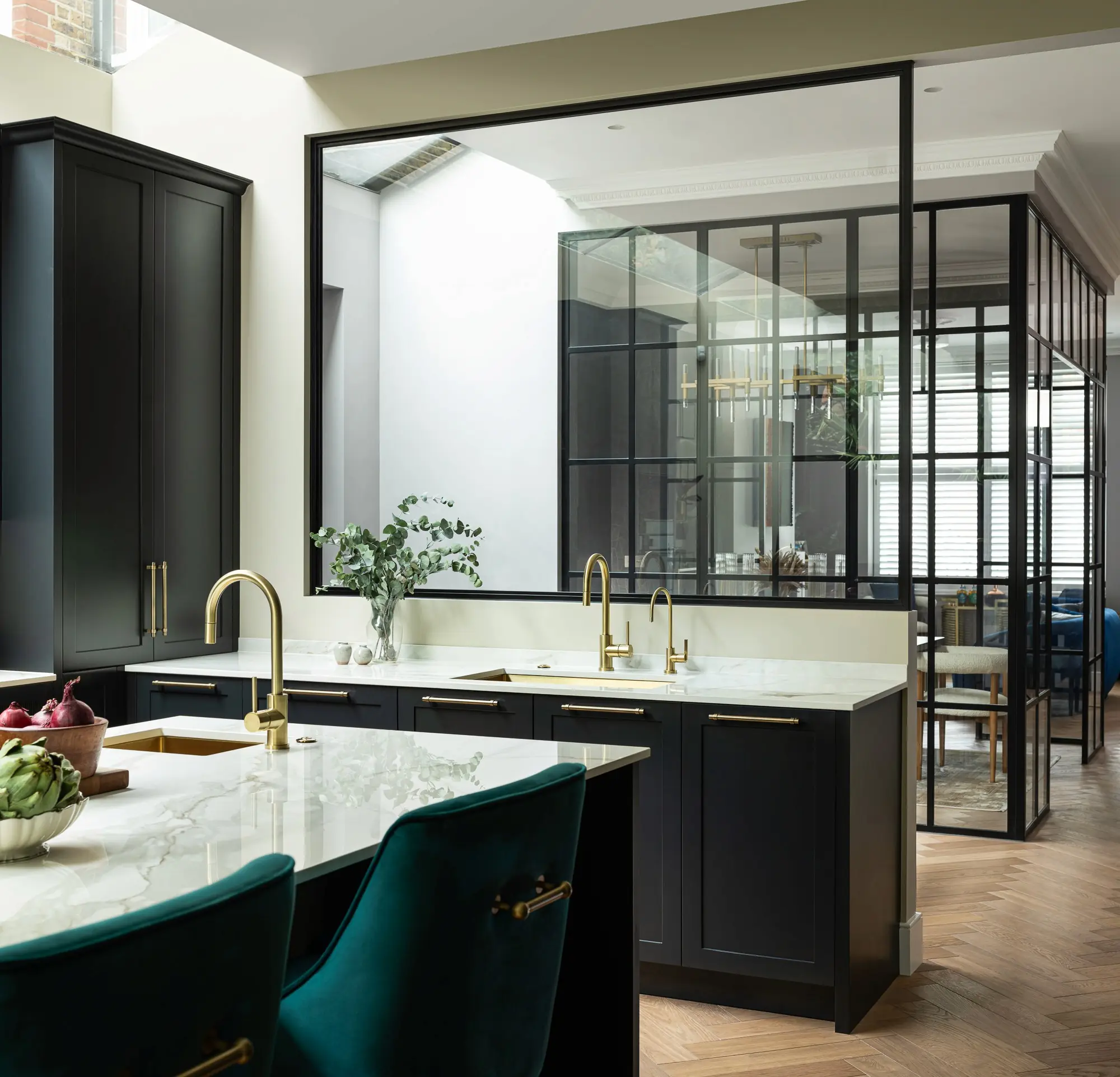Kitchen island with green stools and glazed screen