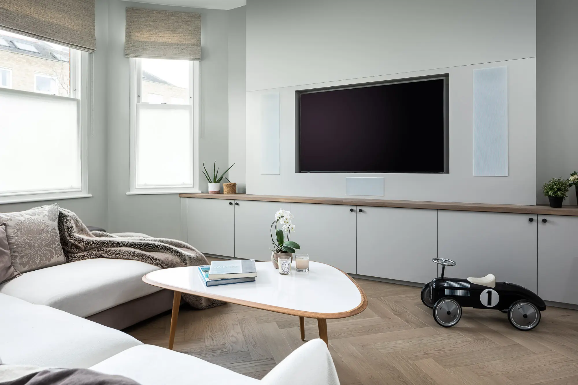 Family room with built-in units and lit shelving