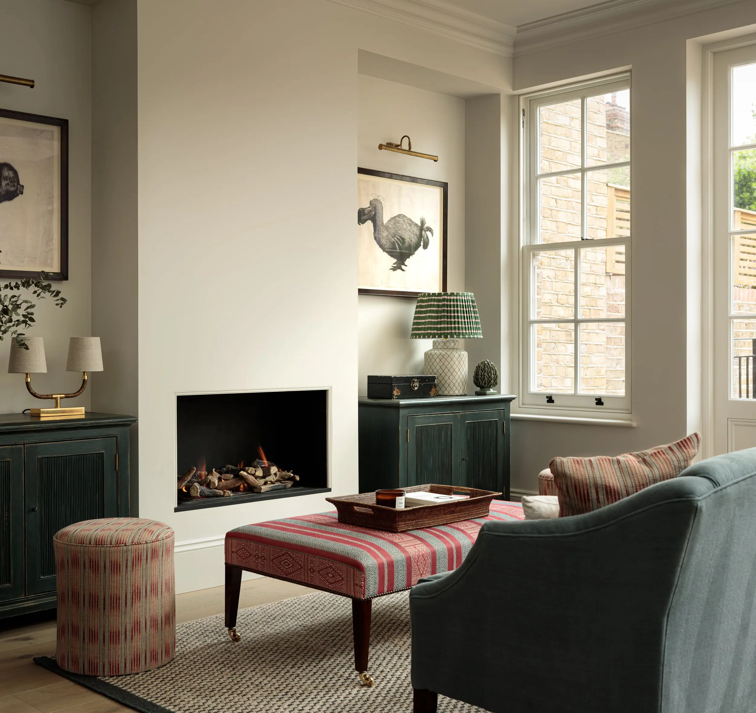 Sitting room with inset fire and green cabinets