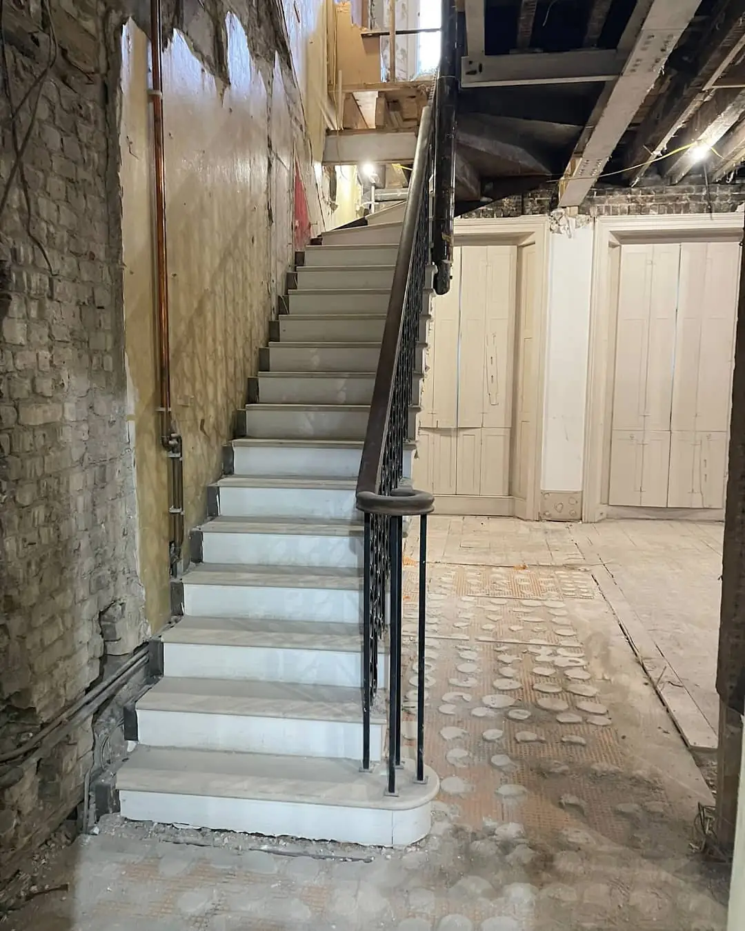 The stone stair and iron balustrade during the strip-out, December 2021.