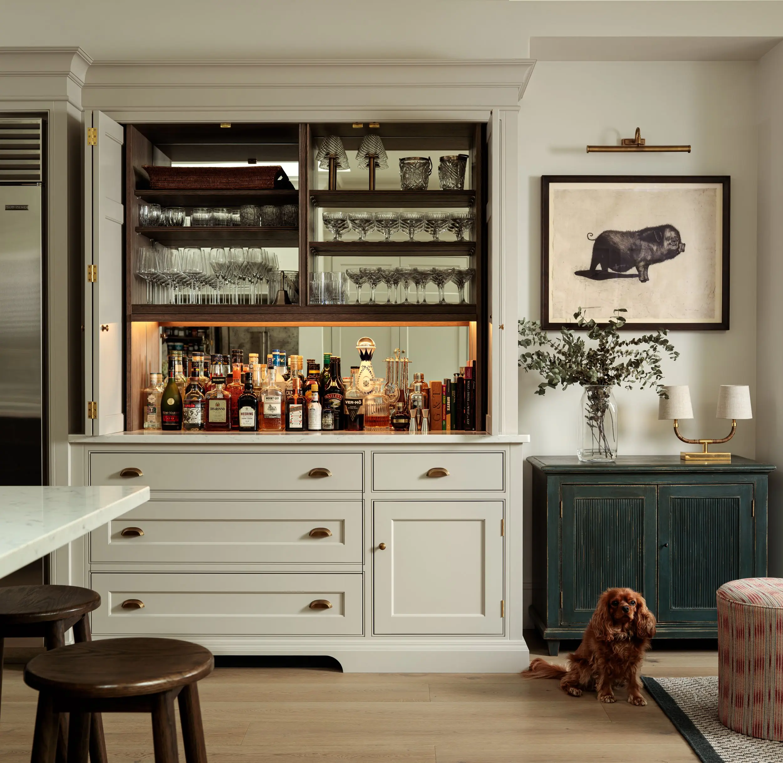 Drinks cupboard opened beside the kitchen bar