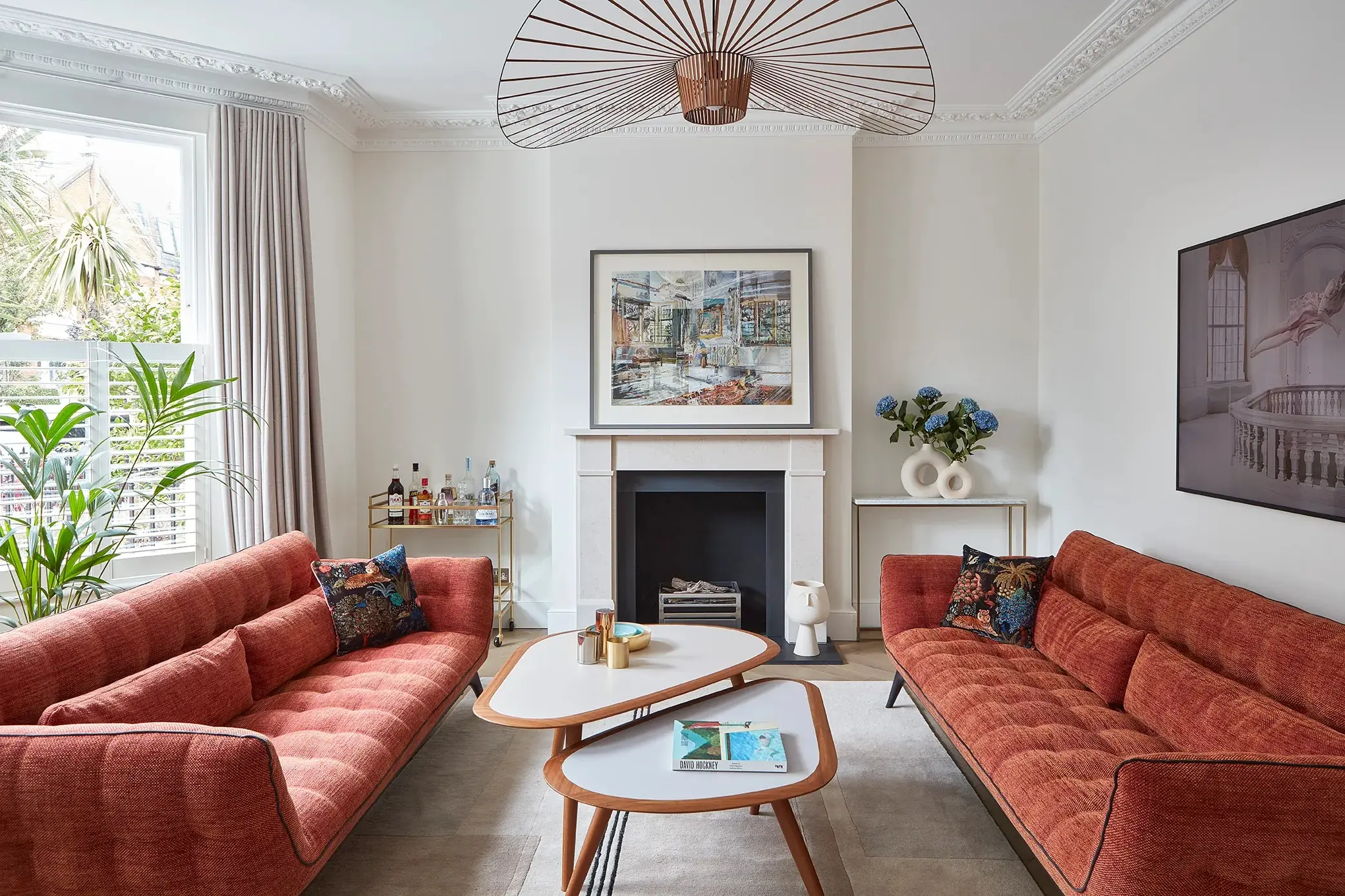 Front living room with fireplace and red sofas
