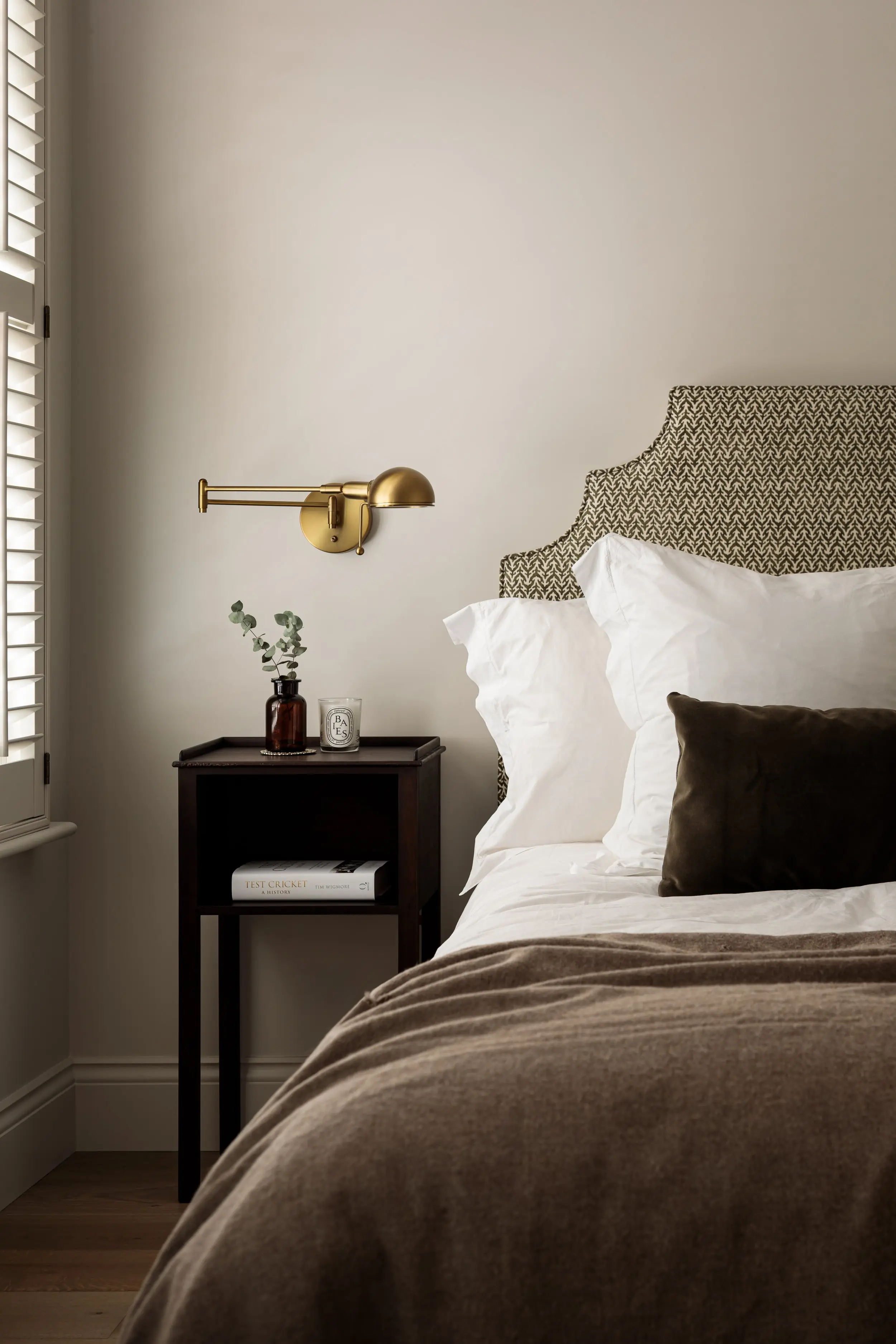 Bedside table and brass light in a bedroom