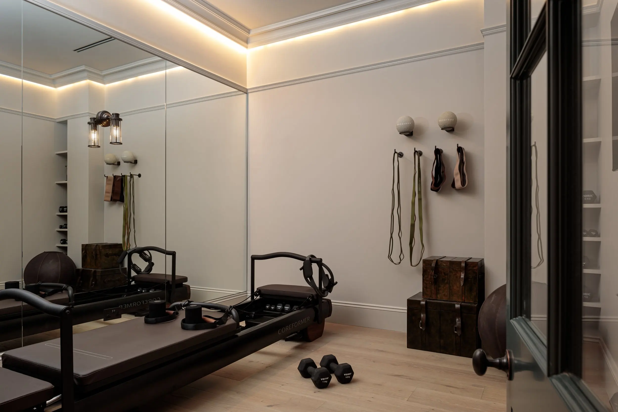 Reformer Pilates room with mirrored wall