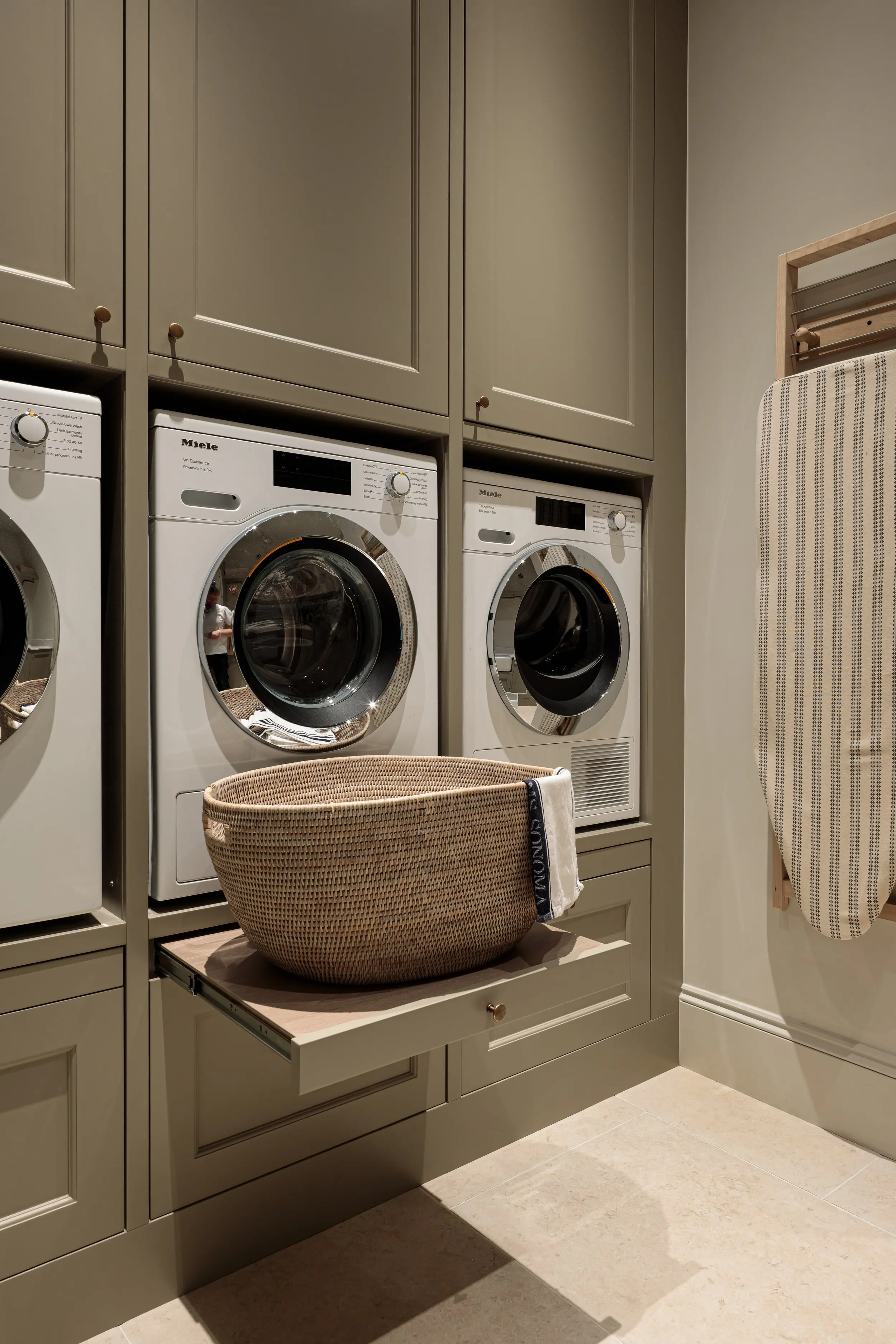 Utility room with washing machines and fitted cupboards