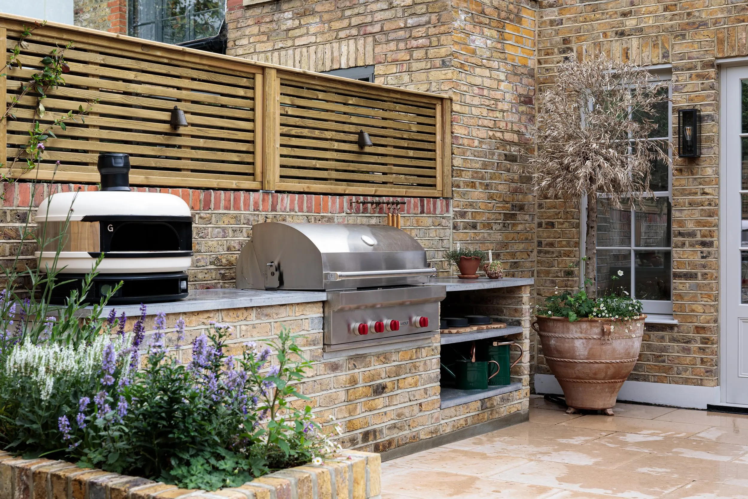 Outdoor kitchen with pizza oven and grill