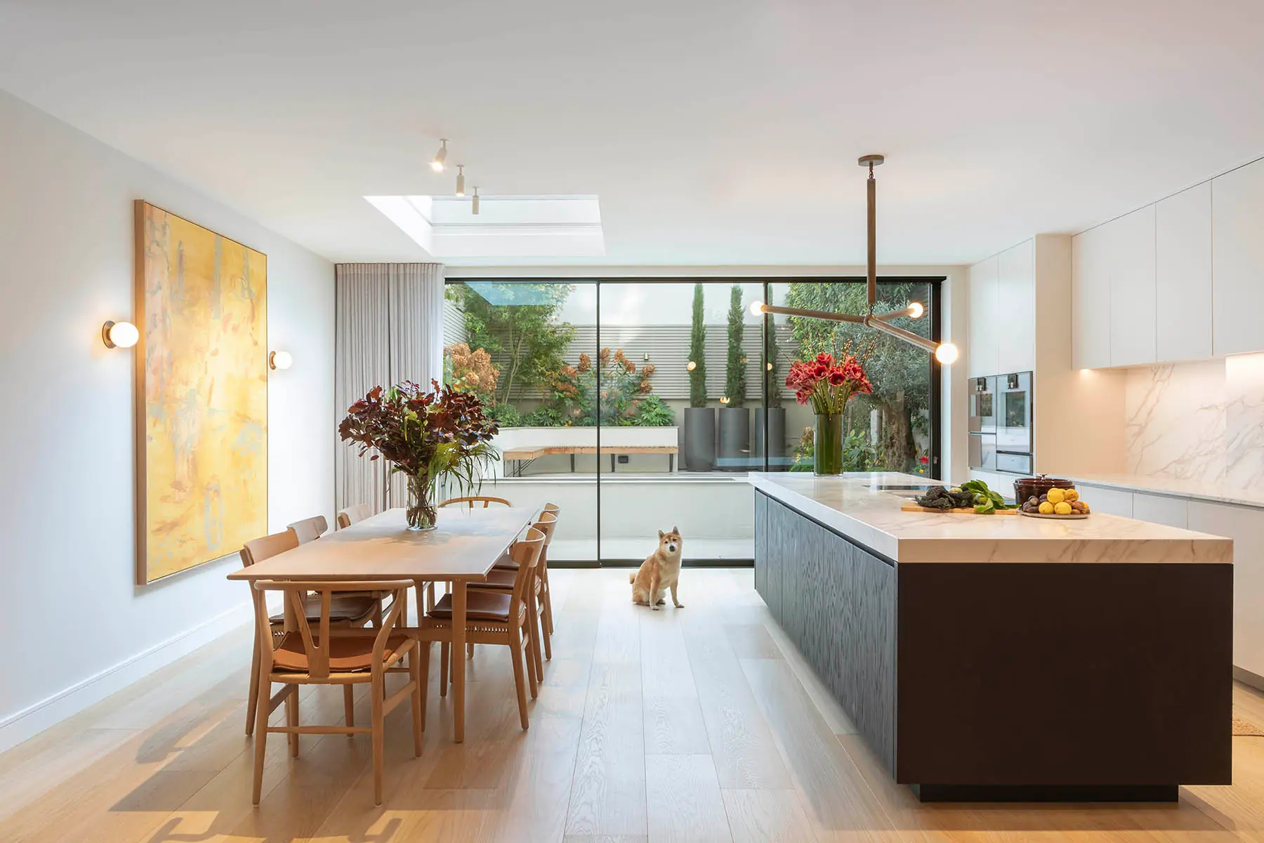 Kitchen island and dining table under the rooflight