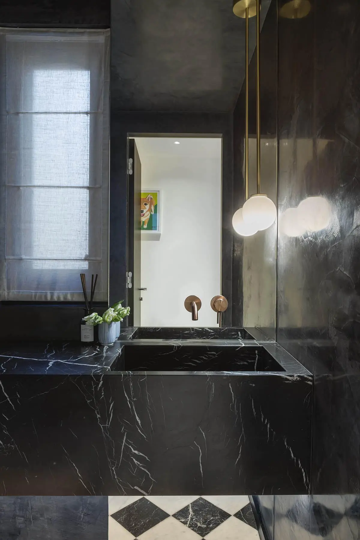 Black marble bath with brass fittings