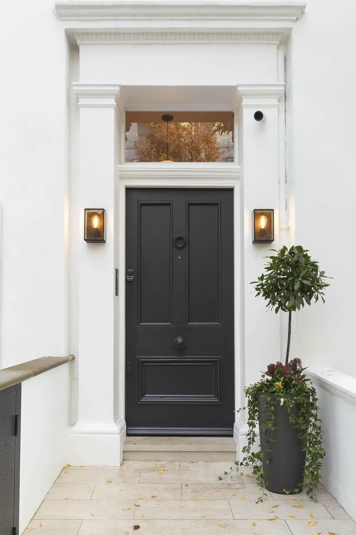 Black front door under white stucco